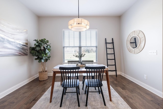 dining space with baseboards and dark wood-style flooring