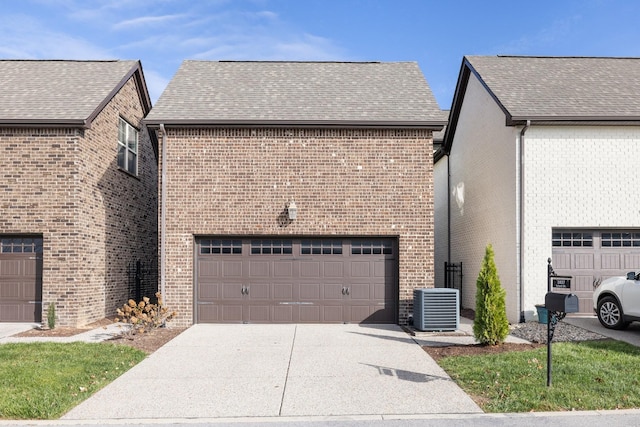 view of home's exterior featuring cooling unit, a shingled roof, concrete driveway, a garage, and brick siding