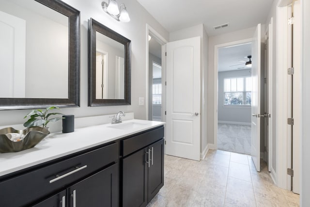 bathroom with visible vents, baseboards, and vanity