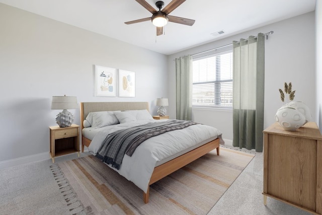 bedroom featuring light colored carpet, visible vents, and baseboards