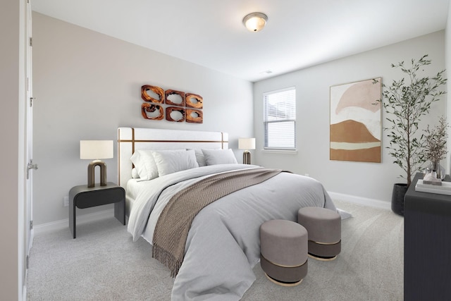 bedroom with baseboards and light carpet