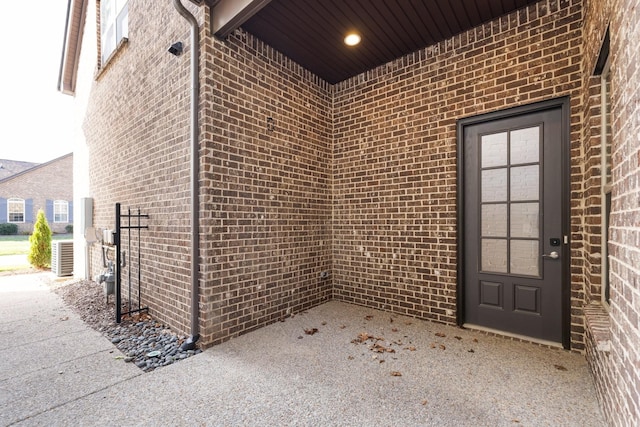 property entrance featuring brick siding