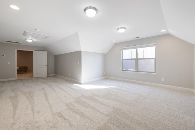 bonus room with light carpet, visible vents, baseboards, and vaulted ceiling