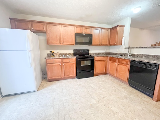 kitchen with a textured ceiling, black appliances, brown cabinets, and a sink