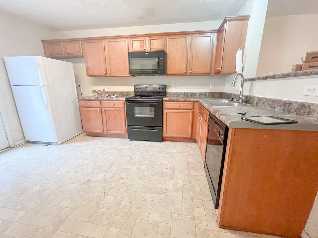 kitchen with a sink and black appliances