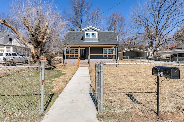 view of front facade with a detached carport, a porch, a fenced front yard, and roof with shingles