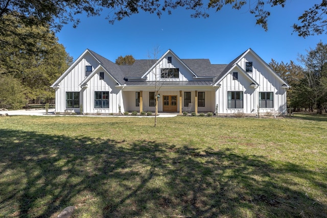 modern farmhouse featuring metal roof, board and batten siding, a front lawn, and a standing seam roof