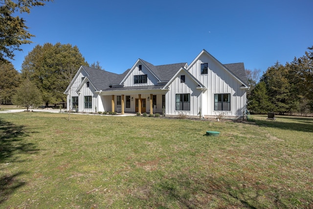 modern inspired farmhouse featuring a standing seam roof, a porch, a front lawn, board and batten siding, and metal roof