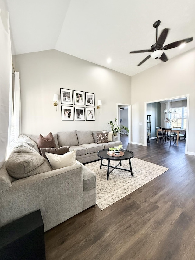 living room with dark wood-style floors, baseboards, a ceiling fan, and lofted ceiling