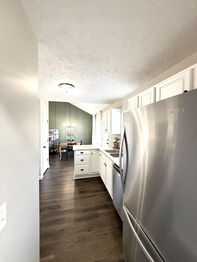 kitchen featuring a sink, dark wood-type flooring, white cabinets, light countertops, and appliances with stainless steel finishes