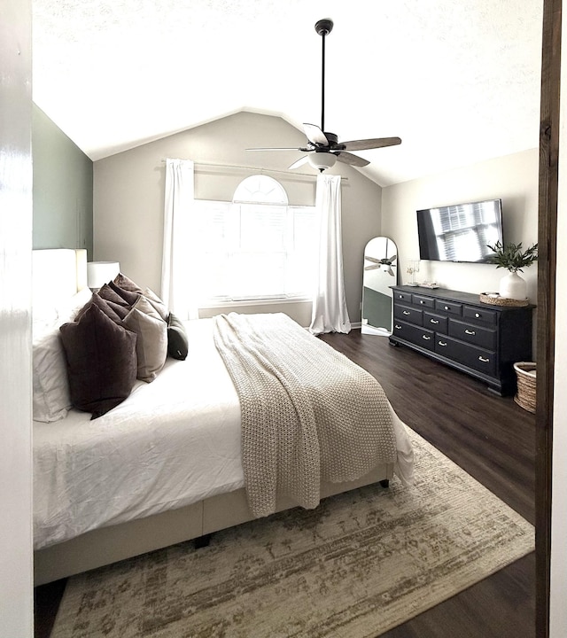 bedroom with wood finished floors, a ceiling fan, and vaulted ceiling