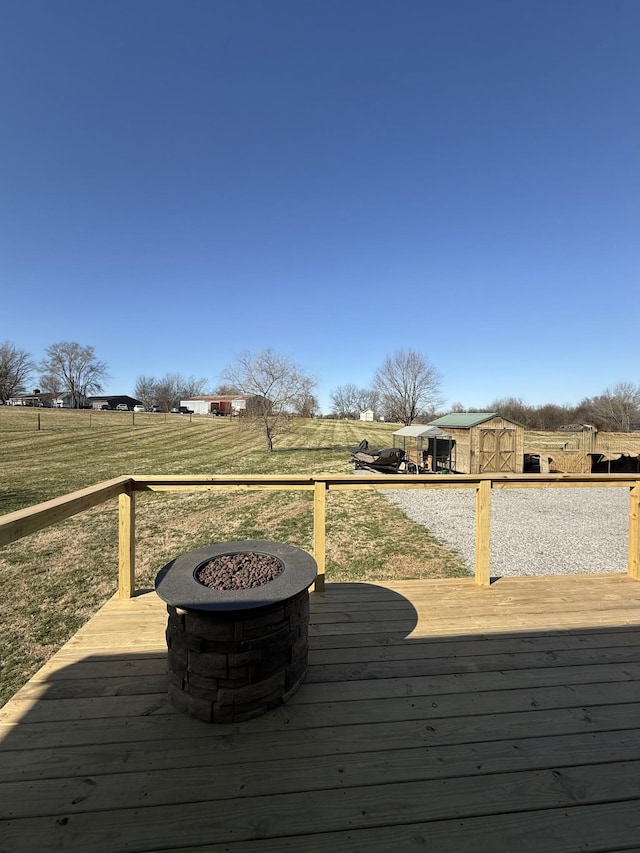 deck featuring a fire pit and a rural view