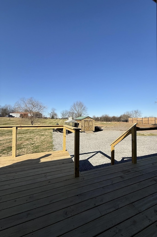 deck featuring a storage shed and an outdoor structure