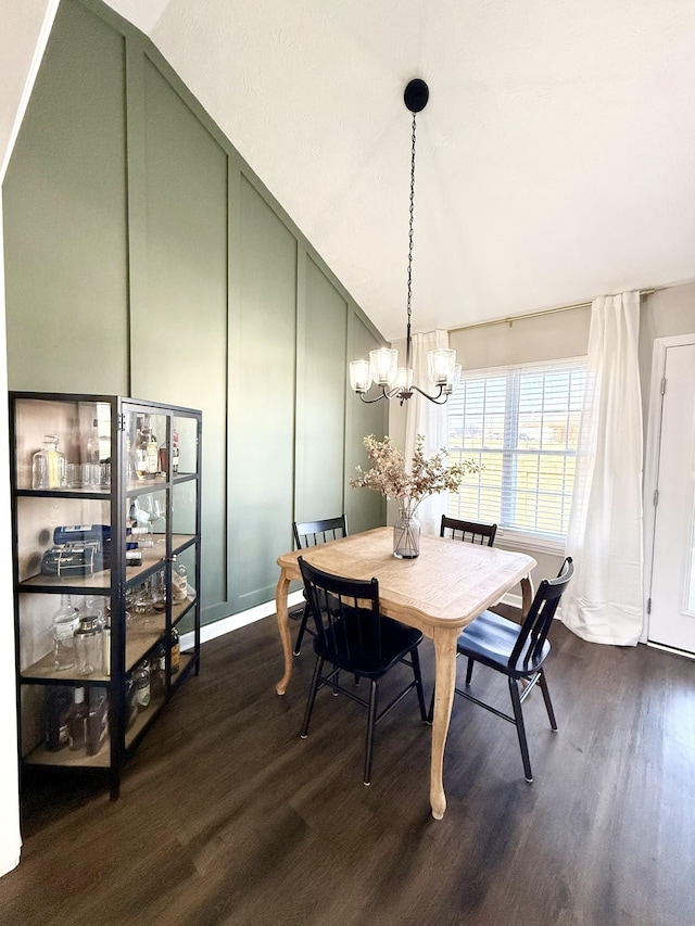 dining space featuring an inviting chandelier and dark wood-style flooring