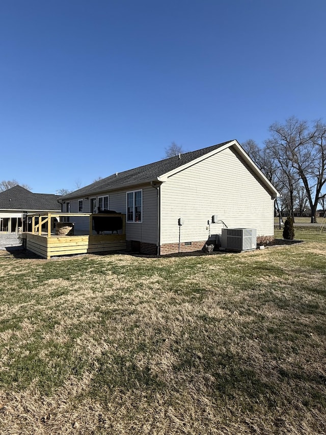 rear view of house featuring a wooden deck, a lawn, central AC, and crawl space