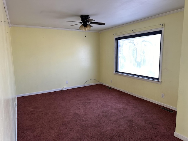 empty room with visible vents, baseboards, ornamental molding, and dark carpet