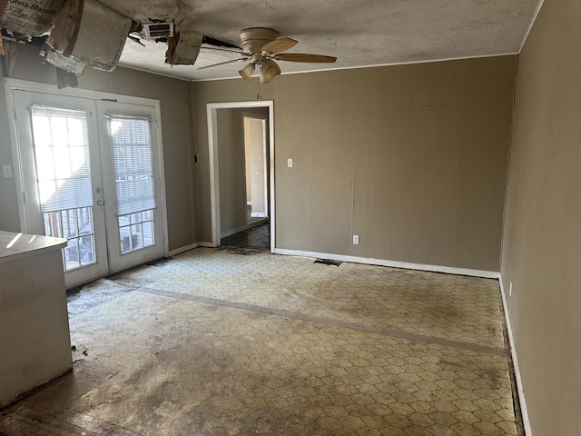 spare room featuring french doors, visible vents, and a textured ceiling