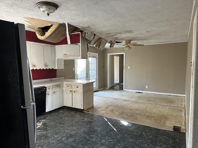 kitchen featuring light countertops, black dishwasher, a peninsula, freestanding refrigerator, and a textured ceiling