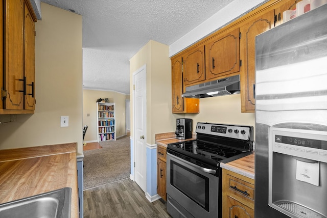 kitchen featuring under cabinet range hood, appliances with stainless steel finishes, a textured ceiling, and light countertops