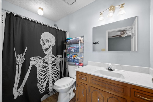 full bathroom featuring toilet, a textured ceiling, vanity, and a ceiling fan