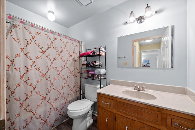 bathroom with curtained shower, toilet, and vanity