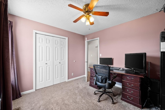 office space featuring baseboards, carpet floors, a textured ceiling, and ceiling fan