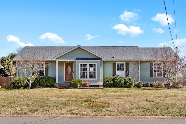 ranch-style house with cooling unit, roof with shingles, a front yard, and fence