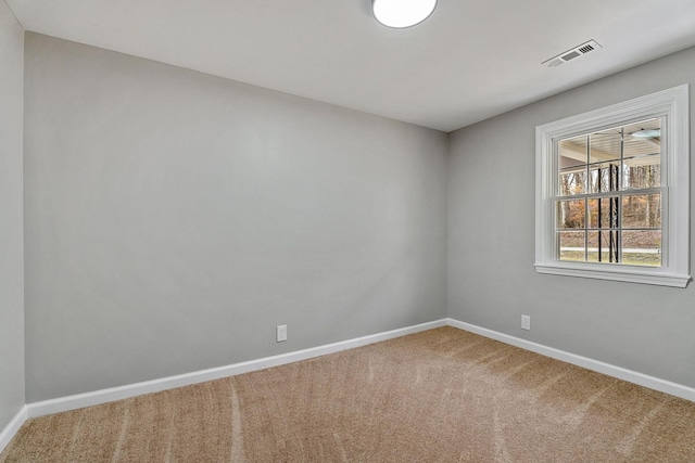 unfurnished room featuring baseboards, visible vents, and carpet floors