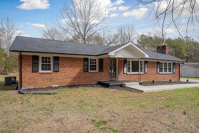 single story home with brick siding, central AC, a chimney, and a front lawn