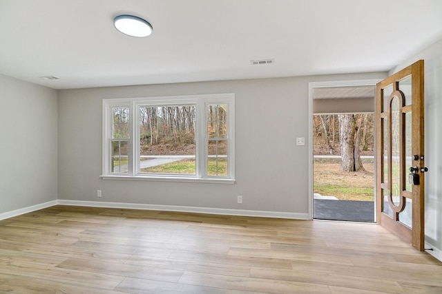 interior space with visible vents, baseboards, and light wood-type flooring