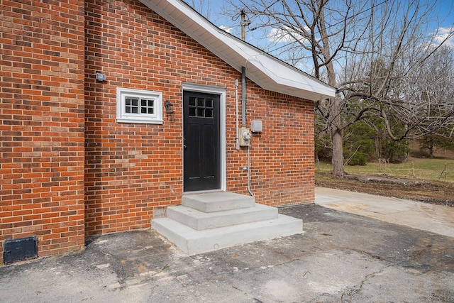 property entrance featuring brick siding