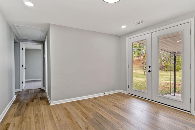 interior space with french doors, baseboards, and light wood-style floors