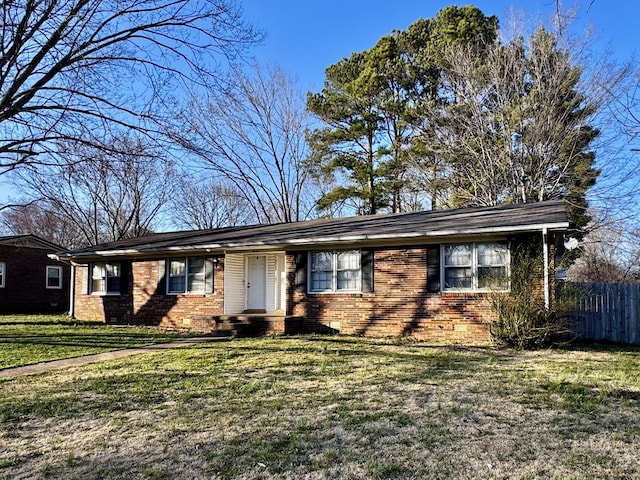 ranch-style house featuring a front lawn, fence, and brick siding