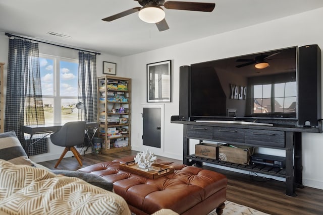 living area featuring a ceiling fan, wood finished floors, and baseboards