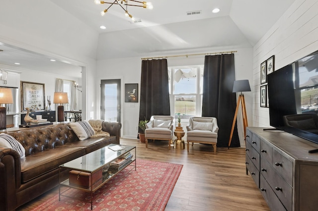 living room with a chandelier, wood finished floors, and high vaulted ceiling