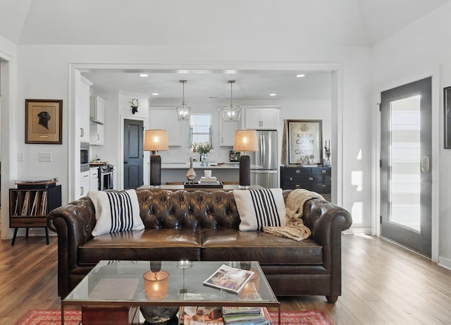 living area with wood finished floors and recessed lighting
