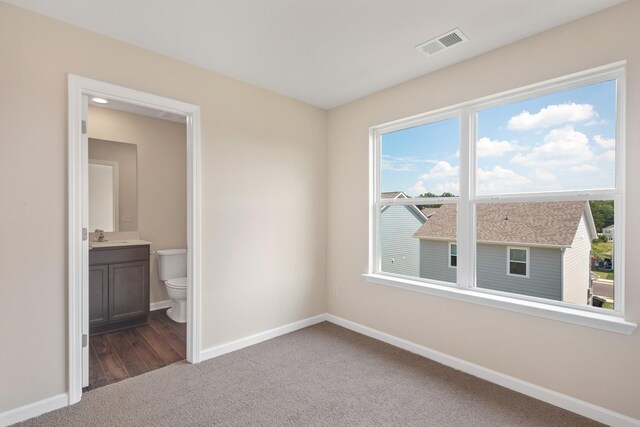 6078 Cullen Dr, La Vergne, TN 37086 - spare room with baseboards, visible vents, dark carpet, and a sink