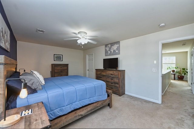 bedroom featuring a ceiling fan, visible vents, light colored carpet, and baseboards