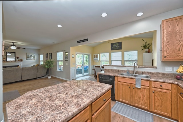 kitchen with black dishwasher, recessed lighting, open floor plan, and a sink