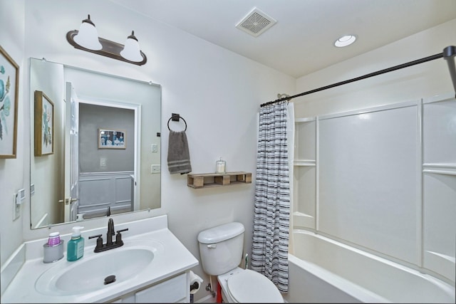 bathroom with visible vents, vanity, toilet, and shower / tub combo with curtain