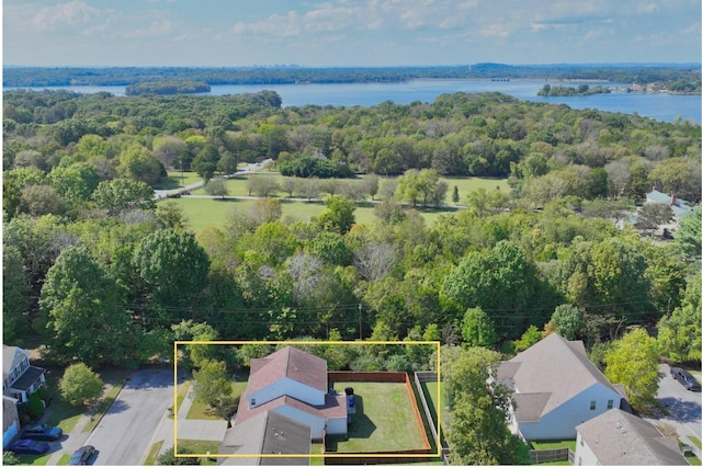 birds eye view of property with a forest view and a water view