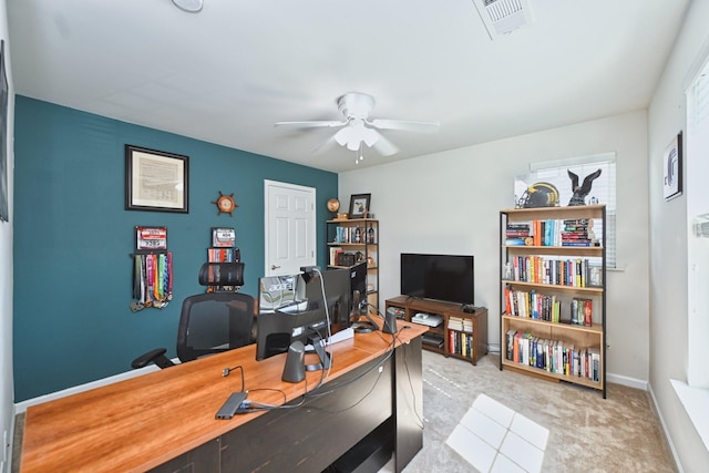 office area featuring visible vents, a ceiling fan, baseboards, and light carpet