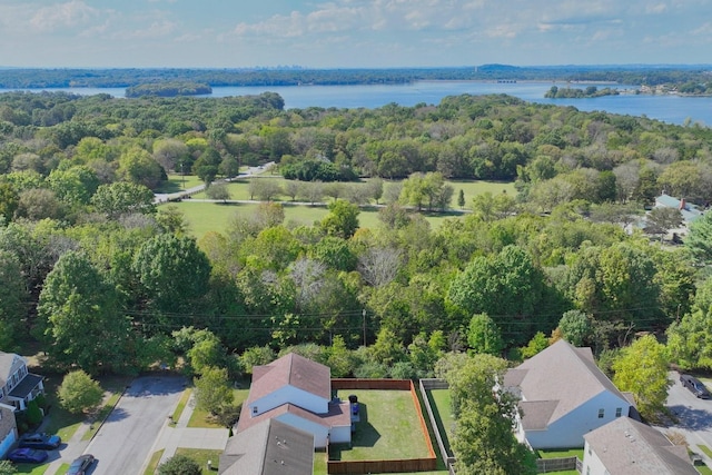 drone / aerial view with a water view and a wooded view