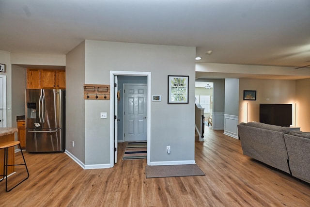 living room with baseboards and light wood finished floors