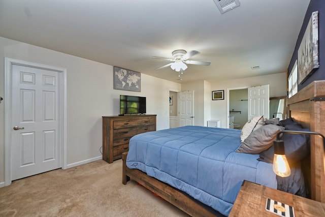 carpeted bedroom featuring visible vents, connected bathroom, a ceiling fan, and baseboards