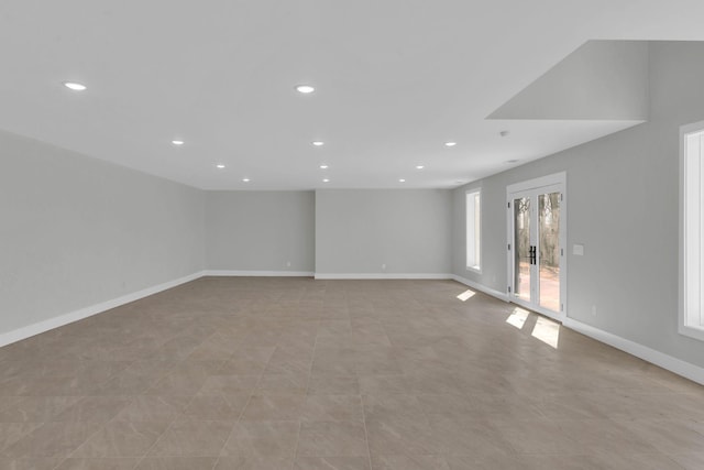 empty room with a wealth of natural light, french doors, baseboards, and recessed lighting