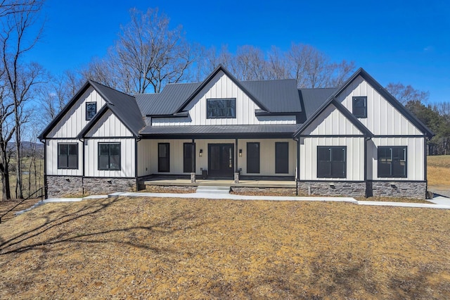 modern farmhouse with a standing seam roof, a porch, board and batten siding, and metal roof