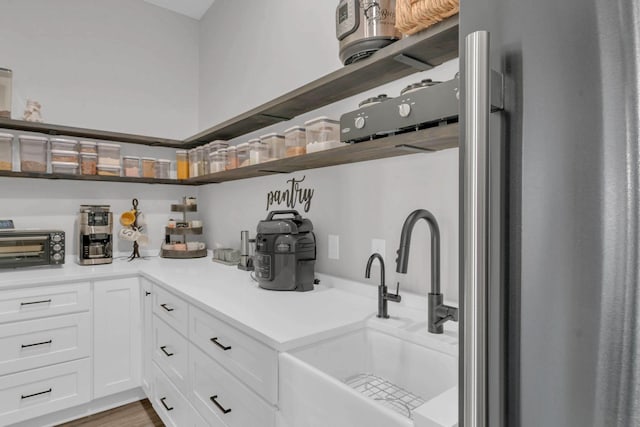 storage area featuring a toaster and a sink