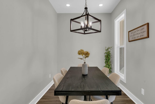 dining room with baseboards, dark wood-type flooring, and a healthy amount of sunlight