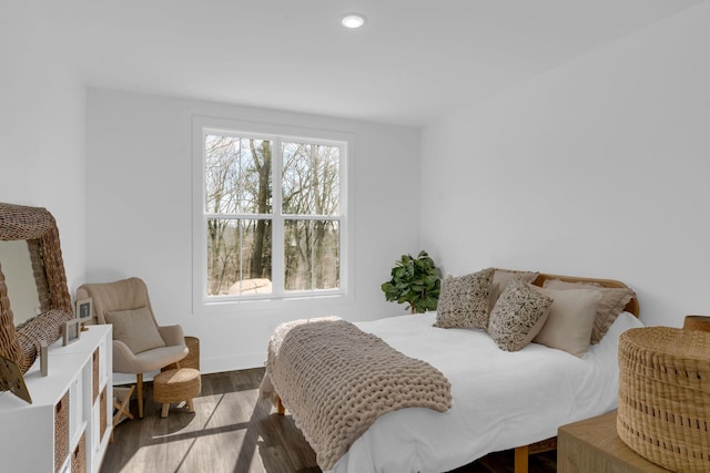 bedroom with recessed lighting and wood finished floors